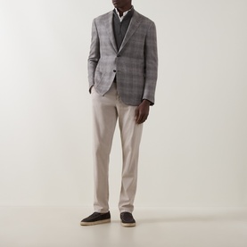 Model wearing Corneliani stone check wool blazer jacket, styled with white shirt, beige trousers and dark loafers