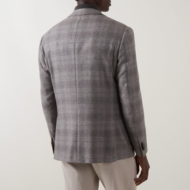 Model wearing Corneliani stone check wool jacket, rear view, styled with light beige trousers