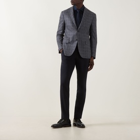 Model wearing Corneliani multi check wool blazer jacket, styled with navy trousers and dark shirt, dark leather loafers
