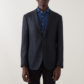 Model wearing Corneliani navy check wool blazer jacket, styled with blue shirt and black trousers, two-button single-breasted
