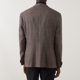 Model wearing Corneliani brown virgin wool and silk jacket, back view, with dark trousers visible