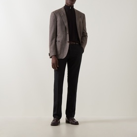 Model wearing Corneliani brown virgin wool and silk jacket with black turtleneck, tailored trousers, and brown leather loafers.