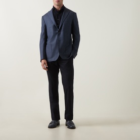 Model wearing Corneliani mid blue virgin wool jacket with black shirt, dark trousers and navy leather shoes.