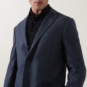 Model wearing Corneliani mid blue virgin wool jacket with notch lapels and button fastening, styled with black roll-neck top