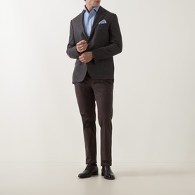 Model wearing Corneliani Hopsack Single-Breasted Blazer in brown, styled with blue shirt, dark trousers, and black oxford shoes.