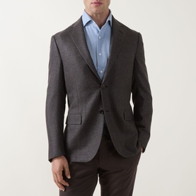 Model wearing Corneliani Hopsack Single-Breasted Blazer in brown, two-button, peak lapels, styled with light blue shirt and dark trousers