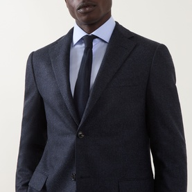 Model wearing Corneliani dark blue wool jacket with notch lapels and two-button fastening, styled with light blue shirt and navy tie