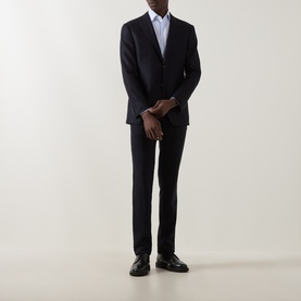 Model wearing Corneliani navy virgin wool and cashmere jacket, styled with matching trousers and black dress shoes.