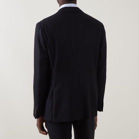 Model wearing Corneliani navy virgin wool and cashmere jacket, rear view showing tailored cut and sleeve button detail.