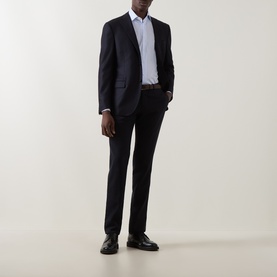 Model wearing Corneliani navy virgin wool cashmere blend jacket, styled with matching trousers, white shirt, and black leather shoes.