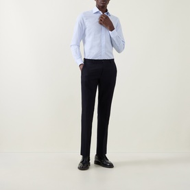 Model wearing Corneliani blue single cuff regular cotton formal shirt, styled with navy tailored trousers and black leather dress shoes.