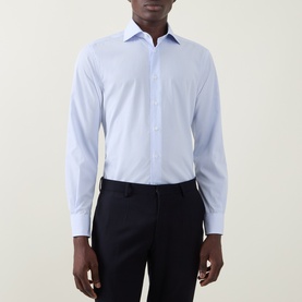 Model wearing Corneliani blue single cuff regular fit cotton formal shirt, styled with navy tailored trousers.