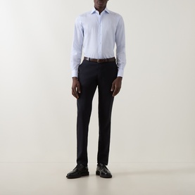 Model wearing Corneliani blue single cuff regular cotton formal shirt, styled with dark navy trousers, brown belt, and black loafers.