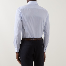 Model wearing Corneliani blue single cuff regular cotton formal shirt, styled with dark navy trousers and brown leather belt, rear view.