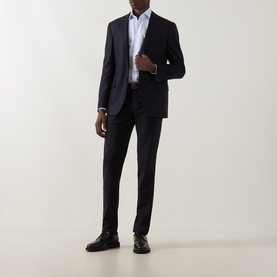 Model wearing Corneliani blue single cuff regular cotton shirt, styled with navy suit and black leather shoes.