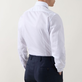Model wearing Corneliani Poplin Polkadot Formal Shirt in white, back view, styled with navy tailored trousers.