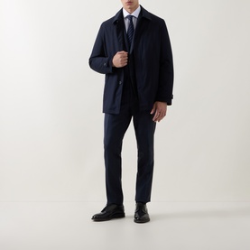 Model wearing Corneliani Poplin Polkadot Formal Shirt in white, styled under a navy coat with matching trousers and black shoes.