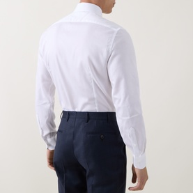 Model wearing Corneliani white single cuff regular cotton formal shirt, styled with navy trousers. Rear view.