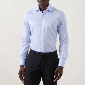 Model wearing Corneliani blue single cuff regular fit cotton formal shirt, styled with navy trousers