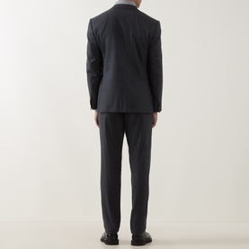 Model wearing Corneliani Flannel Two-Piece Suit in grey, rear view, single-breasted jacket with straight-leg trousers and pressed creases.