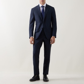 Model wearing Corneliani Micro-Weave Two-Piece Suit in navy, styled with white shirt and blue tie, black Oxford shoes