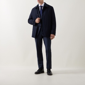 Model wearing Corneliani Micro-Weave Two-Piece Suit in navy, styled with a navy overcoat, blue shirt, tie, and black leather shoes.