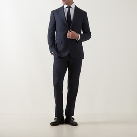 Model wearing Corneliani Tonal Herringbone Two-Piece Suit in dark blue, styled with a white shirt, tie, and brown leather shoes.