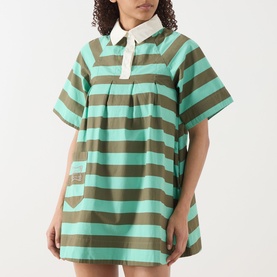 Model wearing Damson Madder Maggie Polo Dress in green and khaki bold stripes, white contrast collar, short sleeves, mini length, relaxed fit
