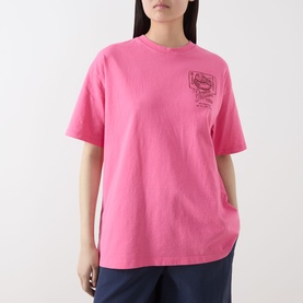 Model wearing Damson Madder Gill Of Dreams Graphic T-Shirt in pink with crew neck, dropped shoulders, and chest graphic print.