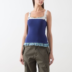 Model wearing Damson Madder navy cotton camisole top with white floral trim straps, blue checked frill hem, styled with khaki cargo trousers.