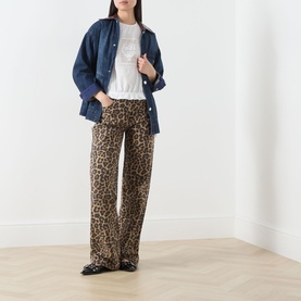 Model wearing Damson Madder white cotton top with denim jacket, leopard print wide-leg trousers and black loafers