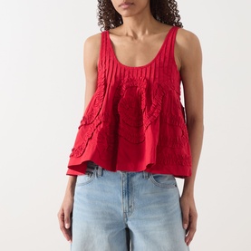 Model wearing Damson Madder Stella Ruffle Cami in red, scoop neck, wide straps, flared hem, styled with light blue jeans.