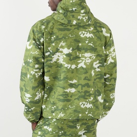 Model wearing BAPE Pixelated Camo Print Logo Windbreaker in green, back view, styled with matching camo trousers