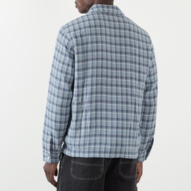 Model wearing BAPE Felt Logo Check Print Shirt in navy check, paired with dark denim jeans. Back view showing straight hem and long sleeves.