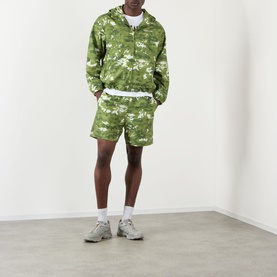 Model wearing BAPE Multi Pixel Camouflage Shorts in green with matching zip-up hoodie, white tee and grey trainers.