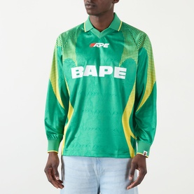 Model wearing BAPE Logo Football Jersey Long-Sleeved T-Shirt in green with yellow side panels and white BAPE logo print