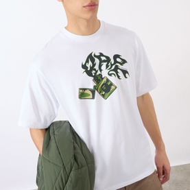Model wearing BAPE Lighter Relaxed Fit T-Shirt in white with flame and lighter graphic print, styled with an olive quilted jacket.