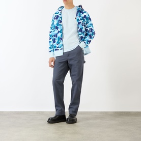 Model wearing BAPE One Point Logo T-Shirt in light blue, styled with blue camo zip hoodie and grey trousers.