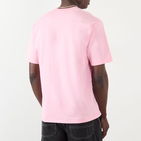 Model wearing BAPE Spray Ape Head Logo T-Shirt in pink, back view, round neck, short sleeves, styled with dark jeans.