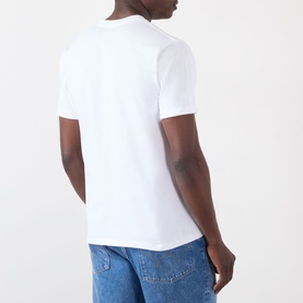Model wearing BAPE white cotton T-shirt, back view, styled with blue jeans