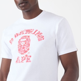 Model wearing BAPE white cotton T-shirt with red camo college ape graphic print on chest