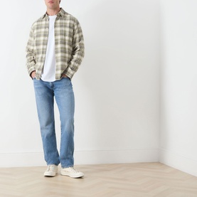 Model wearing Citizens of Humanity Elijah Straight-Leg Trousers in Shadow Blue, styled with olive plaid overshirt and white tee