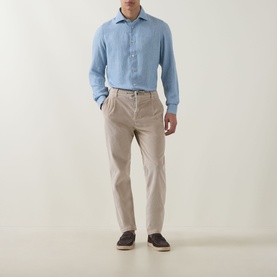 Model wearing Eleventy blue casual shirt with beige chinos and dark loafers