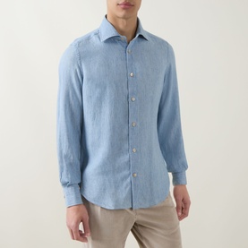 Model wearing Eleventy blue casual shirt with spread collar and button front, styled with beige trousers
