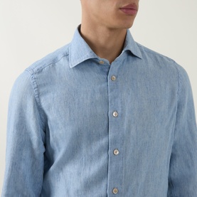 Model wearing Eleventy blue cotton casual shirt, spread collar and natural-tone buttons visible in close-up shot