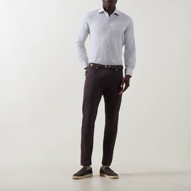 Model wearing Eleventy casual shirt in Grigio Chiaro Melange cotton, styled with dark tapered trousers, brown belt and navy loafers