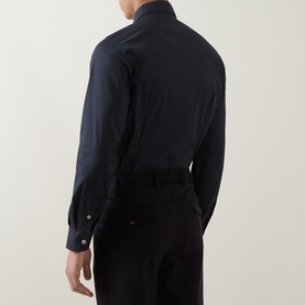 Model wearing Eleventy Dandy Casual Shirt in Blu, back view, showing pointed collar, long sleeves and button cuffs, styled with black trousers.