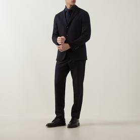 Model wearing Eleventy Dandy Casual Shirt in Blu, styled with a dark navy suit jacket and tailored trousers, paired with black leather shoes.