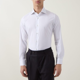Model wearing Eleventy white slim-fit casual shirt with spread collar and button placket, styled with navy tailored trousers.