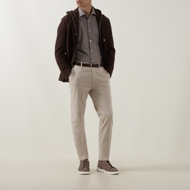 Model wearing Eleventy Dandy Houndstooth Shirt in burgundy, styled with brown cardigan, grey jumper, stone trousers and dark trainers.